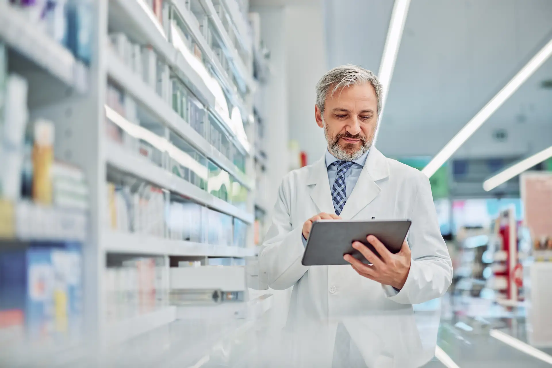 Pharmacist looking at tablet